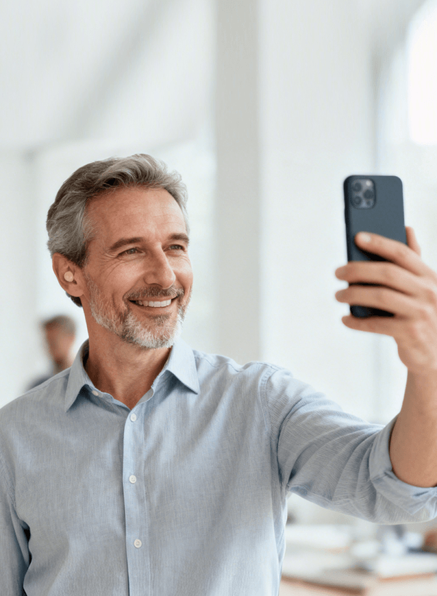 A man wearing Tomore ITE hearing aids is making a phone call using the Bluetooth function.