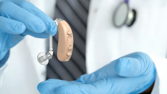 An ENT is holding a TM5007 Hearing Aid
