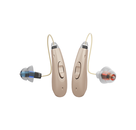 Pair of beige hearing aids on a white background