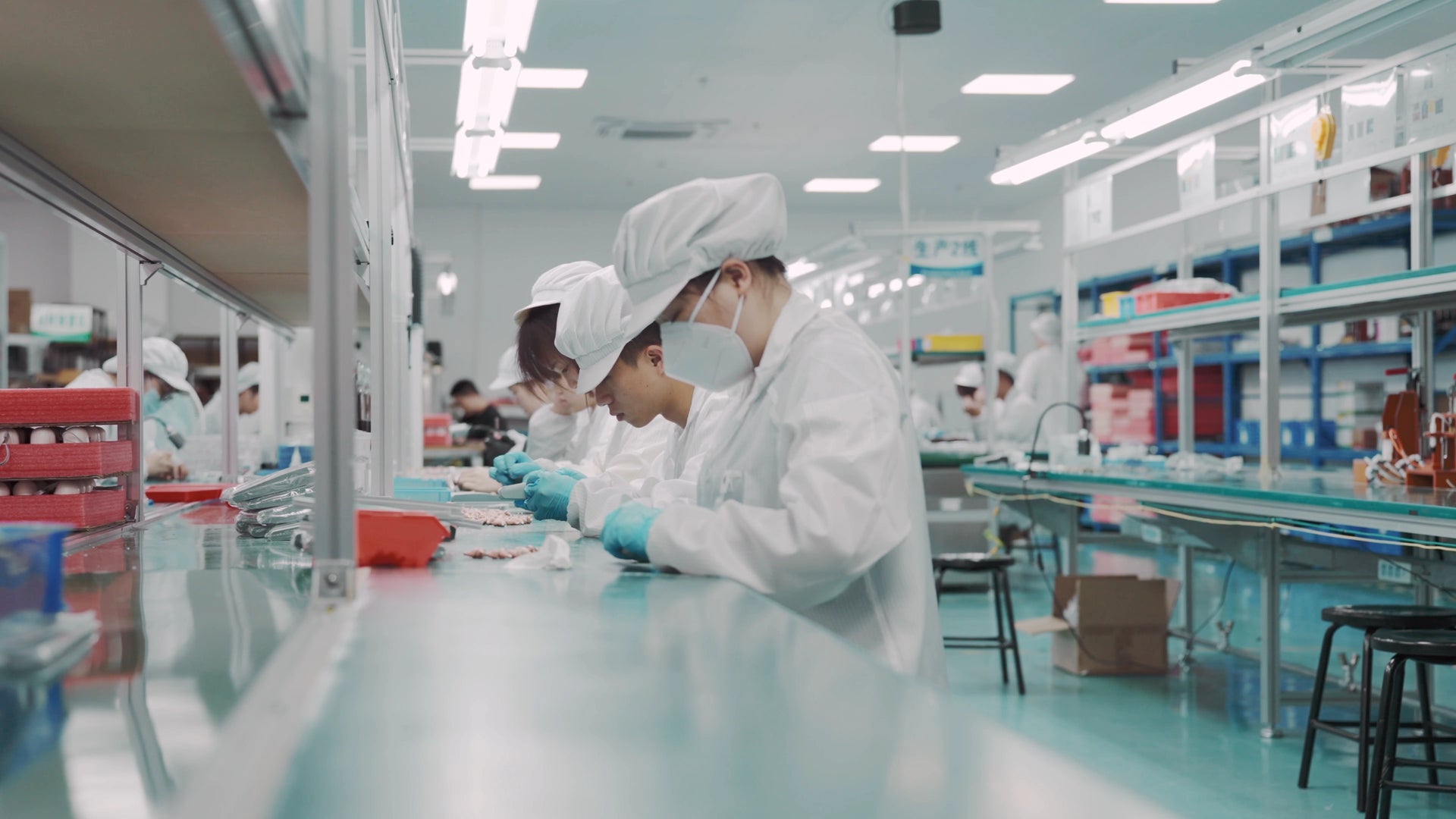 Workers in a cleanroom manufacturing facility.