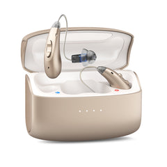 golden hearing aids in a clear case on a white background