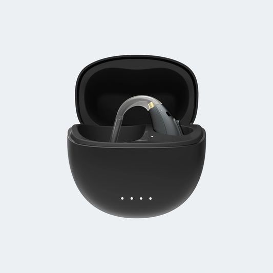 Black BTE hearing aid in a charging case on a light gray background