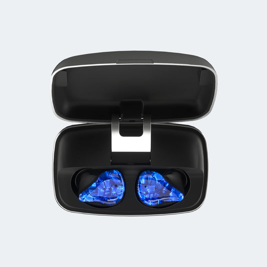A black charging case with blue ITE hearing aids on a light gray background.
